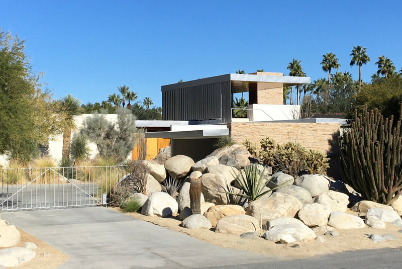 Kaufmann Desert House with driveway, gate, and desert landscaping