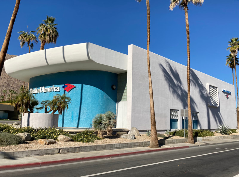 Bank of America building in Palm Springs with palm trees and mountains